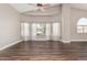 Bright living room with bay window, ceiling fan, and hardwood floors at 439 N Cobblestone St, Gilbert, AZ 85234