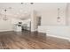 Open-concept living space flowing into the kitchen with modern lighting fixtures at 439 N Cobblestone St, Gilbert, AZ 85234