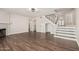 Inviting living room with beautiful dark wood floors, fireplace, and open staircase at 439 N Cobblestone St, Gilbert, AZ 85234