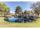 Scenic community pond featuring a waterfall and the 'Stonecreek' sign, surrounded by lush landscaping at 439 N Cobblestone St, Gilbert, AZ 85234