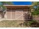 Rustic backyard shed with horizontal paneling and a sliding barn door, adding storage space at 439 N Cobblestone St, Gilbert, AZ 85234