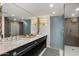 Modern bathroom with a double vanity, a large mirror, and a luxurious glass-enclosed shower at 4446 E Camelback Rd # 104, Phoenix, AZ 85018