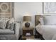 Relaxing bedroom with a comfortable sitting area and a stylish lamp on a wooden nightstand at 4446 E Camelback Rd # 104, Phoenix, AZ 85018