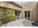 Private front courtyard with desert landscaping and a textured exterior elevation of the home at 4446 E Camelback Rd # 104, Phoenix, AZ 85018