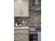 Detailed view of the kitchen showing modern appliances and stylish backsplash for enhanced appeal at 4446 E Camelback Rd # 104, Phoenix, AZ 85018