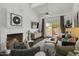 Bright living room features a fireplace, stylish furniture, and a sliding glass door to the outside at 4446 E Camelback Rd # 104, Phoenix, AZ 85018