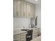 Desk area features built in cabinets with neutral tones and a cactus as decor in the home office at 4446 E Camelback Rd # 104, Phoenix, AZ 85018