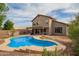 A home exterior with a patio cover over a backyard with a kidney-shaped pool, offering space and shade at 4604 E Summerhaven Dr, Phoenix, AZ 85044