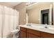 Bathroom with double sinks, a toilet, and a shower with a curtain at 4604 E Summerhaven Dr, Phoenix, AZ 85044