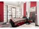 Simple bedroom with striped accent walls, a ceiling fan, hard surface floors and a closet shelving unit at 4604 E Summerhaven Dr, Phoenix, AZ 85044