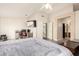 Spacious bedroom featuring a mounted TV, and entrance to the restroom at 4604 E Summerhaven Dr, Phoenix, AZ 85044