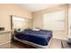 Simple bedroom with gray walls, hard surface floors, and a bed with a silver headboard at 4604 E Summerhaven Dr, Phoenix, AZ 85044