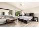 Bright bedroom featuring a ceiling fan, sitting area, and wood-look flooring at 4604 E Summerhaven Dr, Phoenix, AZ 85044