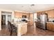 Spacious kitchen featuring stainless steel appliances, tile floors, and a breakfast bar with seating at 4604 E Summerhaven Dr, Phoenix, AZ 85044