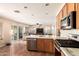 Kitchen with stainless appliances, granite countertops, tile flooring and view into the Gathering room at 4604 E Summerhaven Dr, Phoenix, AZ 85044