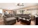 Cozy living room with a large gray sectional sofa, open to the kitchen, and lots of natural light at 4604 E Summerhaven Dr, Phoenix, AZ 85044