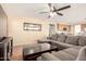 Comfortable living room with tile floors, open to the kitchen, and a large, gray sectional sofa at 4604 E Summerhaven Dr, Phoenix, AZ 85044