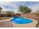 Inviting backyard pool with a tile water feature and concrete surround offers relaxation and outdoor fun at 4604 E Summerhaven Dr, Phoenix, AZ 85044