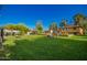 Manicured lawn and landscaping in a backyard featuring a covered patio at 4612 W Waltann W Ln, Glendale, AZ 85306
