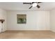 This bedroom features a window and wall-mounted lamps with a neutral color palette at 4612 W Waltann W Ln, Glendale, AZ 85306