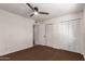 A bedroom featuring a ceiling fan, carpet, and a closet that provides storage at 4612 W Waltann W Ln, Glendale, AZ 85306