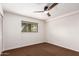 A bright bedroom with a ceiling fan, a window, and neutral carpeting at 4612 W Waltann W Ln, Glendale, AZ 85306