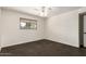 A bright bedroom with a ceiling fan, window, and neutral carpeting at 4612 W Waltann W Ln, Glendale, AZ 85306