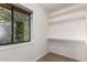 This closet offers shelves, a clothing rod, and a window for natural light at 4612 W Waltann W Ln, Glendale, AZ 85306