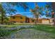 Charming home featuring a well-manicured lawn, mature trees, and colorful flower beds at 4612 W Waltann W Ln, Glendale, AZ 85306