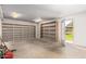 Large garage space with storage shelving and an exit to the backyard at 4612 W Waltann W Ln, Glendale, AZ 85306