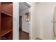 A hallway with tile floors, built-in shelves, and a view to the outside at 4612 W Waltann W Ln, Glendale, AZ 85306