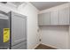 This home's functional laundry room features ample cabinet space and modern gray tones at 4612 W Waltann W Ln, Glendale, AZ 85306