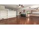 Inviting living room seamlessly connects to the kitchen with beautiful dark hardwood floors and a built-in entertainment center at 4612 W Waltann W Ln, Glendale, AZ 85306