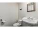 Powder room with a pedestal sink, tile flooring, and a decorative mirror at 4612 W Waltann W Ln, Glendale, AZ 85306