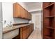 A utility room featuring a sink, cabinetry, and access to the bathroom at 4612 W Waltann W Ln, Glendale, AZ 85306