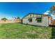 A spacious backyard offering ample room for outdoor activities and relaxation beneath a clear sky at 4728 N 61St Ave, Phoenix, AZ 85033
