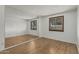 This bedroom features wood-look floors, two windows, and a mirrored wall at 4728 N 61St Ave, Phoenix, AZ 85033