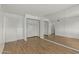 This bedroom features wood-look floors, a mirrored wall, and open closets at 4728 N 61St Ave, Phoenix, AZ 85033