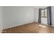 Cozy bedroom featuring wood-look tile flooring and a window allowing natural light at 4728 N 61St Ave, Phoenix, AZ 85033