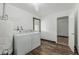 Bright laundry room features white washer, dryer, and wood-look floors, offering convenience and style at 4728 N 61St Ave, Phoenix, AZ 85033
