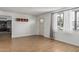 Bright living room with wood-look tile flooring, neutral walls, and natural light from a large window at 4728 N 61St Ave, Phoenix, AZ 85033