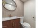 Modern bathroom featuring stylish vanity, a round mirror, and tiled walls at 4901 W Augusta Cir, Glendale, AZ 85308