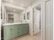 Stylish bathroom featuring green vanity, a large mirror, and modern fixtures at 4901 W Augusta Cir, Glendale, AZ 85308