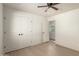 Bright bedroom with ceiling fan, closet and doorway provides comfort and accessibility at 4901 W Augusta Cir, Glendale, AZ 85308