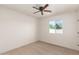 A cozy bedroom showcases a ceiling fan, a window view, and plenty of open space at 4901 W Augusta Cir, Glendale, AZ 85308
