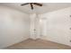 Bright bedroom with a ceiling fan leads to another room, offering spacious and connected living at 4901 W Augusta Cir, Glendale, AZ 85308