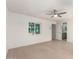 Spacious bedroom with light hardwood floors, a window, and an ensuite bathroom at 4901 W Augusta Cir, Glendale, AZ 85308