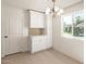 Bright dining area featuring built-in cabinetry, stylish lighting, and a large window with natural light at 4901 W Augusta Cir, Glendale, AZ 85308