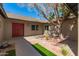 Cozy front entrance features a manicured lawn, rock garden, and unique bare tree at 4901 W Augusta Cir, Glendale, AZ 85308