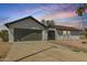 Charming single-story home featuring a two-car garage and landscaped front yard with desert accents at 4901 W Augusta Cir, Glendale, AZ 85308